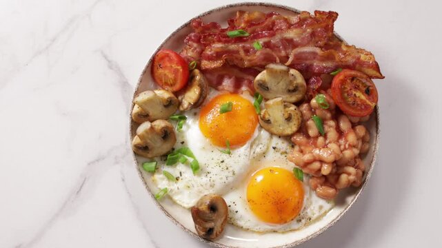 breakfast bacon and two eggs white beans on plate top view zoom food