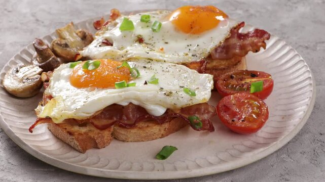 two open sandwithes breakfast bacon and eggs on plate