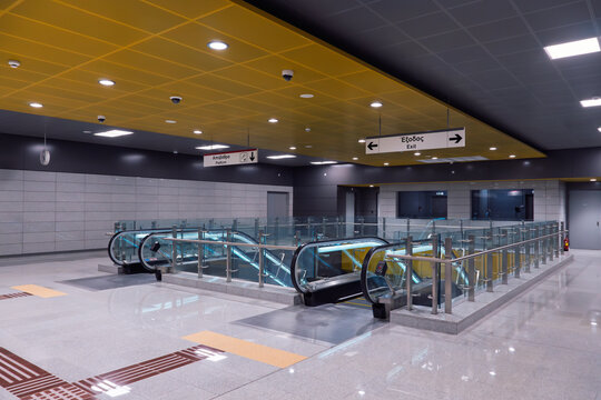 Thessaloniki, Greece Spacious and modern empty underground metro station interior featuring bright lighting, escalators, and sleek architecture.