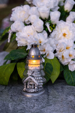 Christmas decoration on a grave: candle in the shape of a Christmas tree.