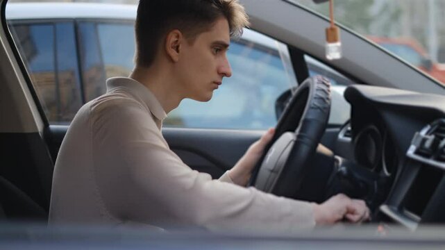 The driver is nervous because he can't start the car, rear view