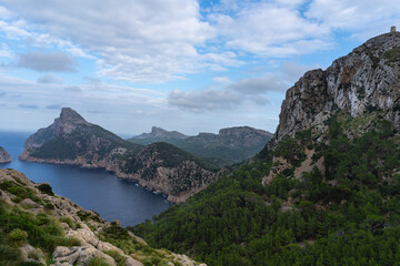 Cap de Formentor, Mallorca, Spain 25.10.2021 - Panoramic view of coastline with pine forest and Mediterranean mountain range