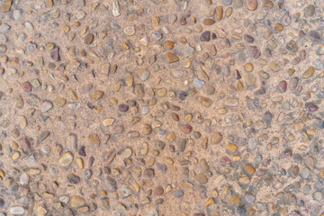 Capdepera, Mallorca, Spain 26.10.2021 Traditional Mediterranean stone pavement with rounded pebbles embedded in sandy concrete