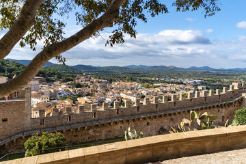 Capdepera, Mallorca, Spain 26.10.2021 View of village rooftops and castle wall with crenellations overlooking mountainous landscape