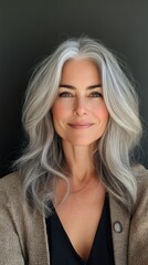 Fototapeta premium Smiling woman with silver hair and natural beauty in a bright indoor setting