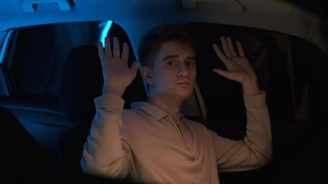 Young traffic offender raises his hands in a sign of surrender to the traffic police