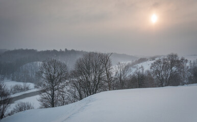 Walk over the river Sluch in the snowfall.