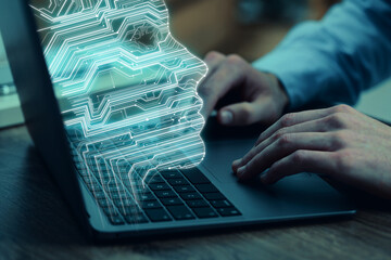 Businessman working on laptop at desk, closeup. Digital head coming out of computer symbolizing artificial intelligence