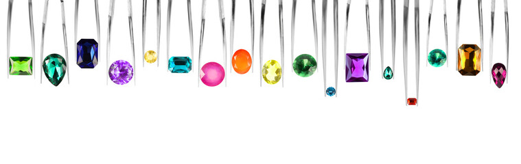 Tweezers with different shiny gemstones on white background, set