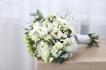 Beautiful wedding bouquet on wooden table indoors