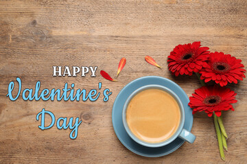 Happy Valentine's Day card with red gerbera flowers and cup of coffee on wooden background. Top view