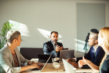 Business team brainstorming in modern office with natural light
