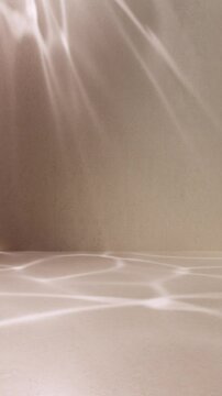 Water caustic light and shadow on concrete wall looped animation background. Seamless blurred sunlight motion effect indoor studio scene.