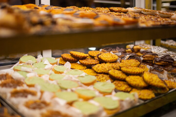 Assortment of different types of cookies on display in a shop window