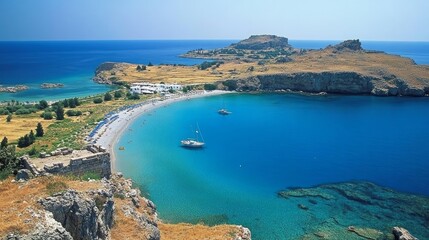 Obraz premium Greece. Rhodes Island. Lindos Acropolis. A view of St. Paul's Bay in the shape of a heart from the summit of the historic Athena Lindia temple, which dates back to the fourth century BC