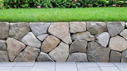 Selbstklebende Fototapeten Hardscaping project with stone retaining wall and greenery for spring garden design © Business Image