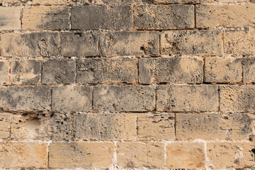 Palma de Mallorca, Spain 29.10.2021: Ancient weathered sandstone wall texture of La Almudaina Palace