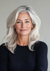 Naklejka premium A woman with long gray hair and a black top