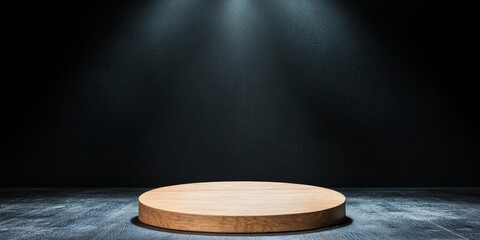 A spotlight shines on a wooden circular platform in a dark space, creating an atmospheric and dramatic effect.