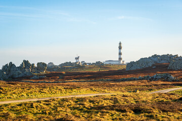 Fototapeta premium Scenic View of Phare du Créac'h Lighthouse on Rugged Landscape in Ouessant, Brittany, France Captured in Serene Light