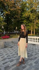 beautiful girl in modest long skirt stands in park