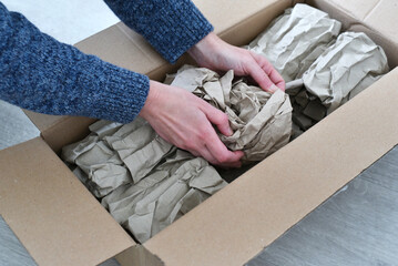 Hands of a woman preparing a package to be sent