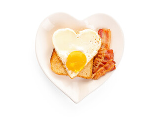 Plate with tasty bacon, heart made of fried egg and toast on white background