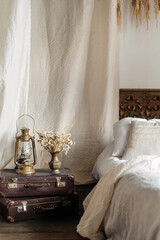 Cozy bohemian bedroom with vintage elements and soft linens © brizmaker