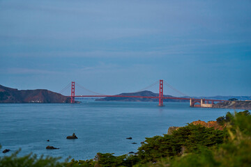 Panoramic view of the large metal red bridge across the bay