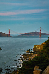 Panoramic view of the large metal red bridge across the bay