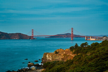 Panoramic view of the large metal red bridge across the bay