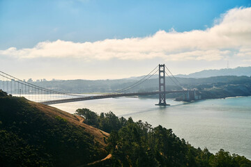 Panoramic view of the large metal red bridge across the bay