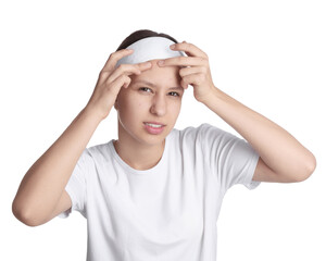 Teenage girl popping pimple on her face against white background. Acne problem