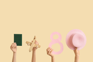 Female hands with paper figure 8, straw hat, passport and starfish on color background. International Women's Day