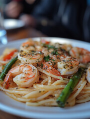 Delightful plate of spaghetti with shrimps and fresh asparagus