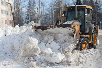 Snow removal in the city. Special equipment for removing snow from the road.
