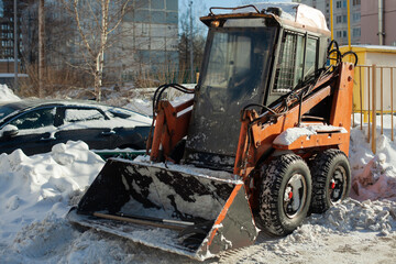 Fototapeta premium Snow removal in the city. Special equipment for removing snow from the road.