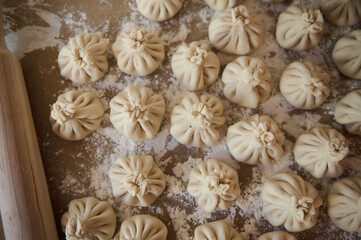 Freshly Prepared Homemade Khinkali Dumplings on a Flour-Dusted Surface