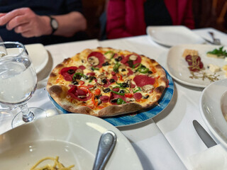 Tasty pepperoni pizza with basil on grey table