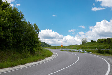 Road signs on curve mountain road, danger concept.