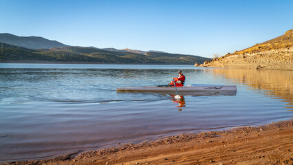 Senior male rower in a coastal rowing shell - Carter Lake in fall or winter scenery in northern Colorado. © MarekPhotoDesign.com