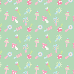 Pattern of various children's rattles on a green background