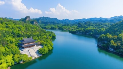 Fototapeta premium Serene chinese landscape with temple by a tranquil lake and lush mountains