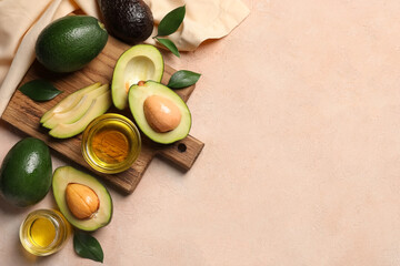 Composition with avocados and oil on beige background, top view