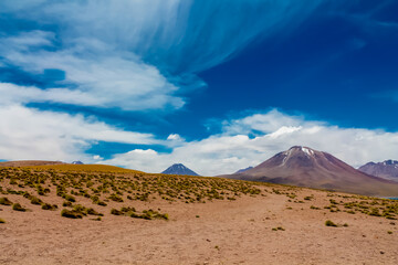 Lakes in the desert Atacama landscape in Chile. The view point to the green crystal lakes, volcanoes and mountains. Lookout Mirador Laguna Miniques and Miscanti in San Pedro de Atacama desert