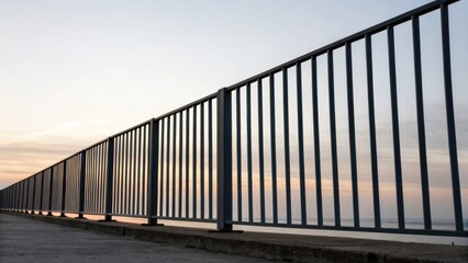 Naklejka premium The railings vertical slats stand in stark contrast against the pale sky highlighting the starkness of the metal as the promise of color and design looms on the horizon.