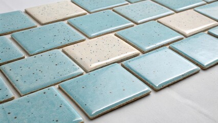 Fototapeta premium A serene arrangement of light blue tiles each softly speckled for visual interest delineated by pale cream grout lines that evoke a calming coastal vibe.