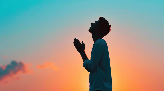 Silhouetted figures kneel in prayer against a stunning sunset, embodying deep repentance and glorifying God with praise.