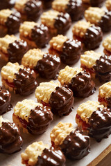 Homemade Christmas cookies filled with strawberry marmalade and dipped in chocolate