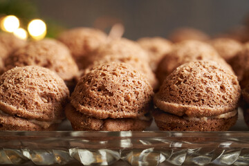 Baked homemade Christmas cookies in the form of nuts filled with cream, close up
